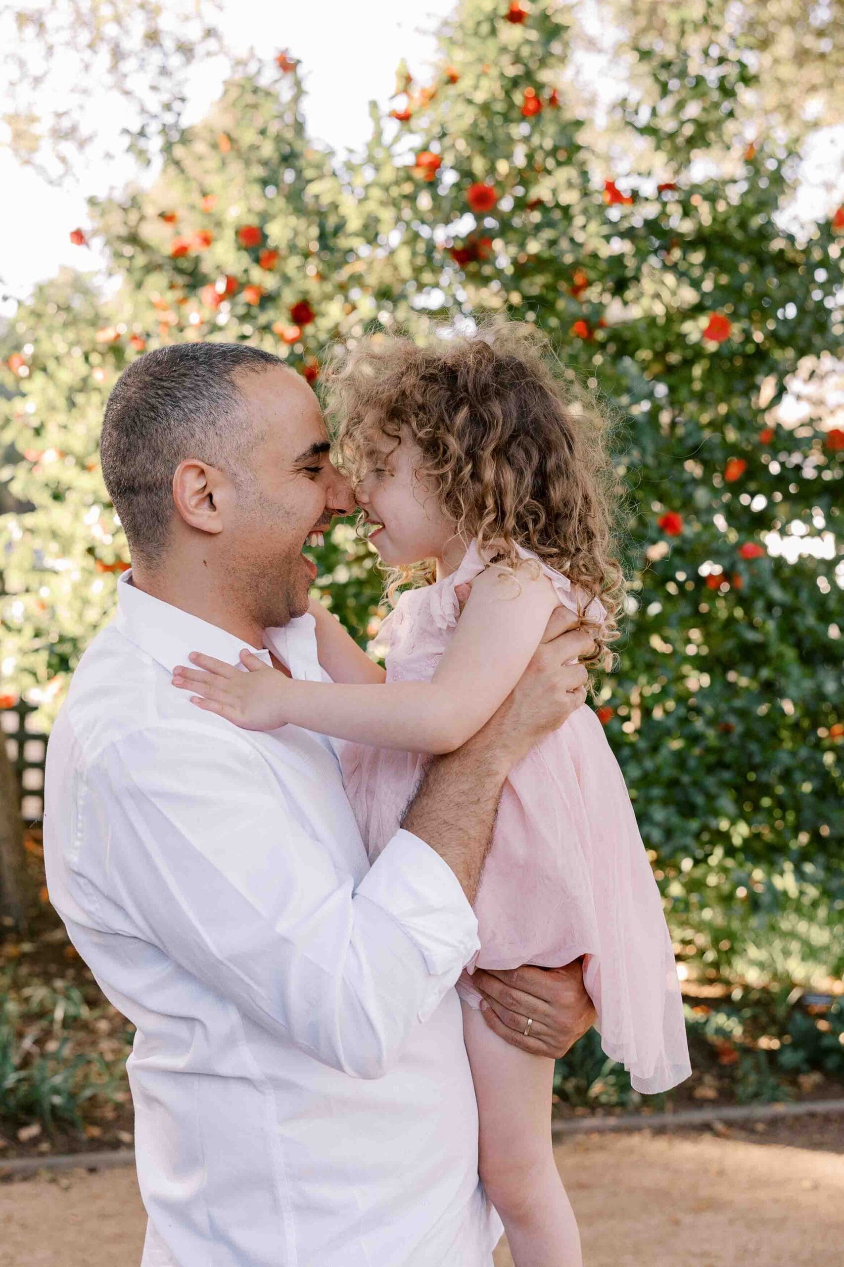 Dad and daughter giving butterfly kisses