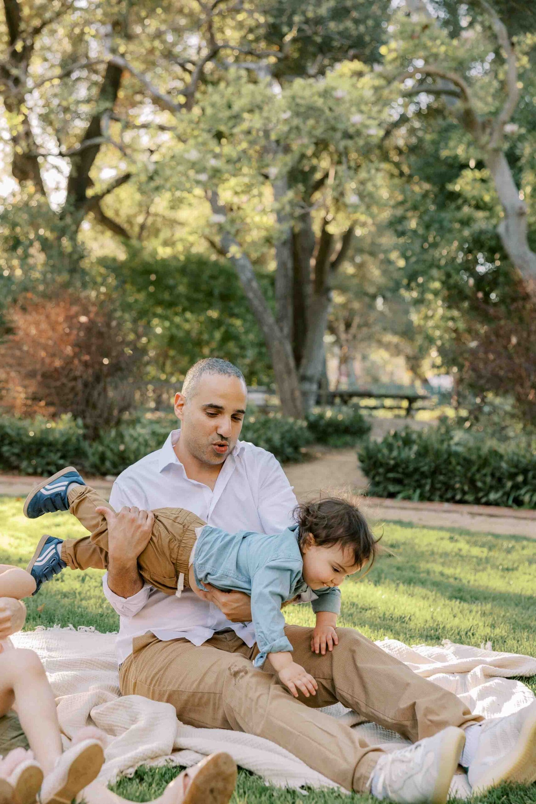 Dad playing airplane with son