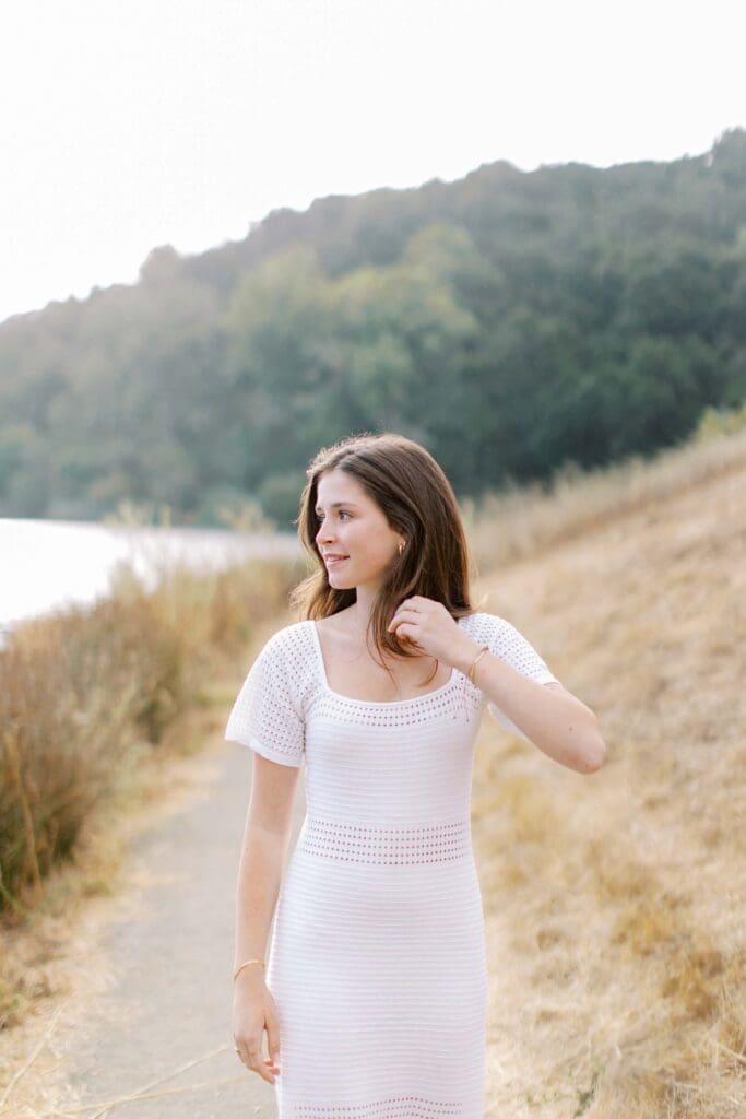 PALY Senior smiling and looking over her shoulder at Foothills Preserve in Palo Alto