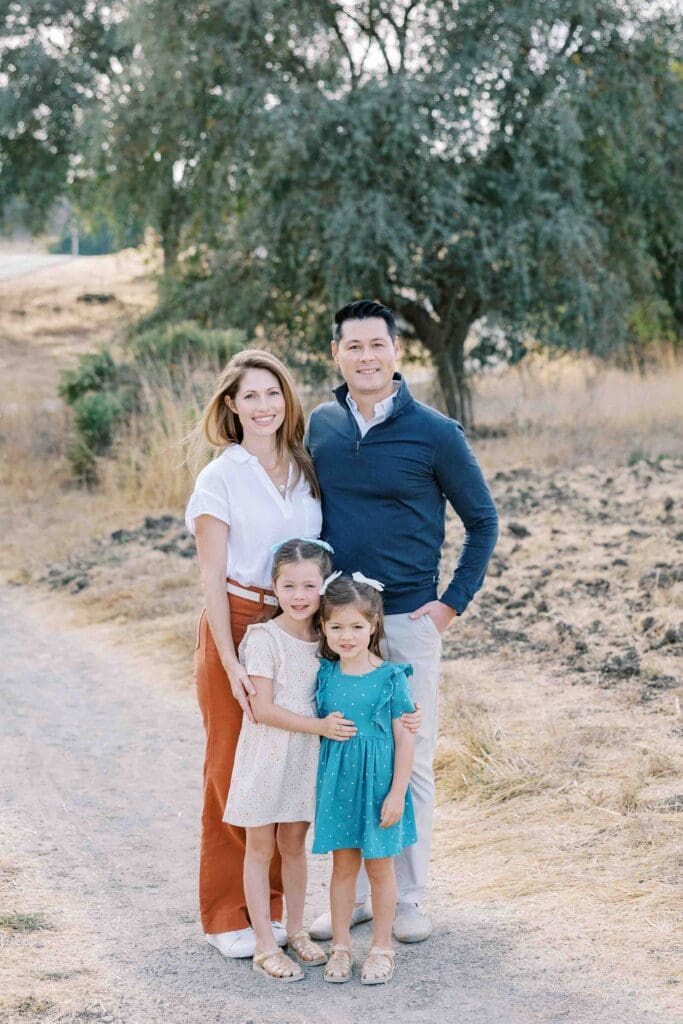 Family of four smiling for the camera at Arastradero Preserve in Palo Alto