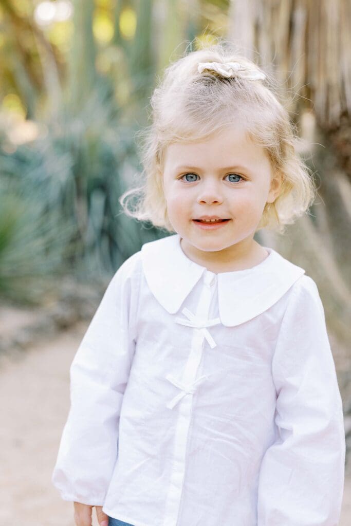 Girl wearing white shirt and smiling at Arizona Cactus Garden in Palo Alto