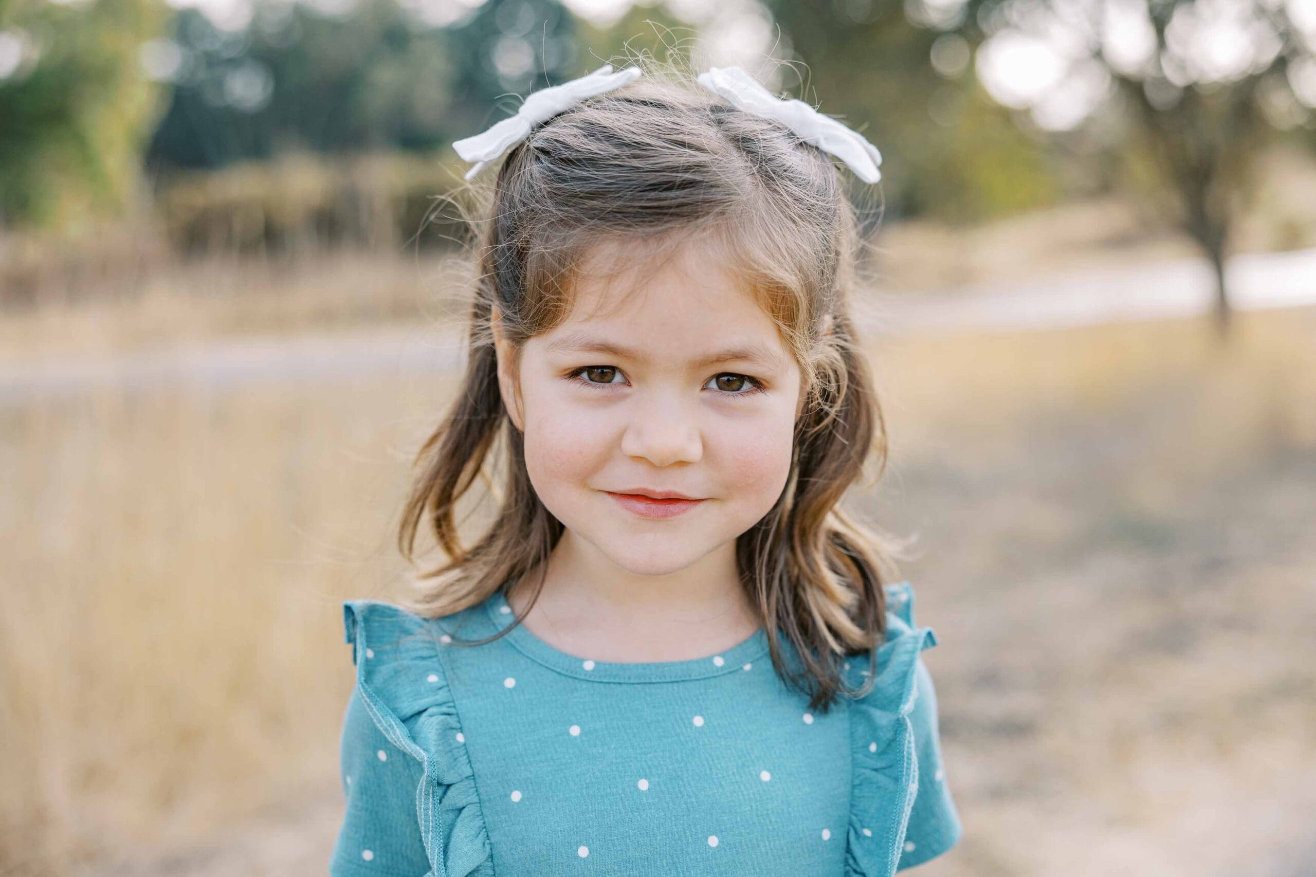 Young girl looking at the camera with a soft smile
