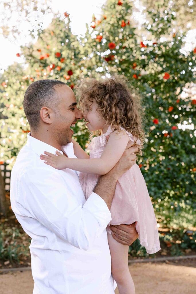 Dad and daughter nuzzling noses