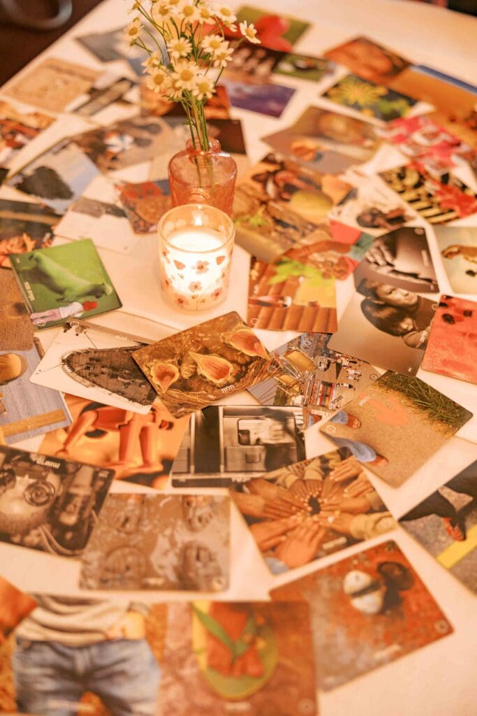 Deck of cards spread out around a lit candle