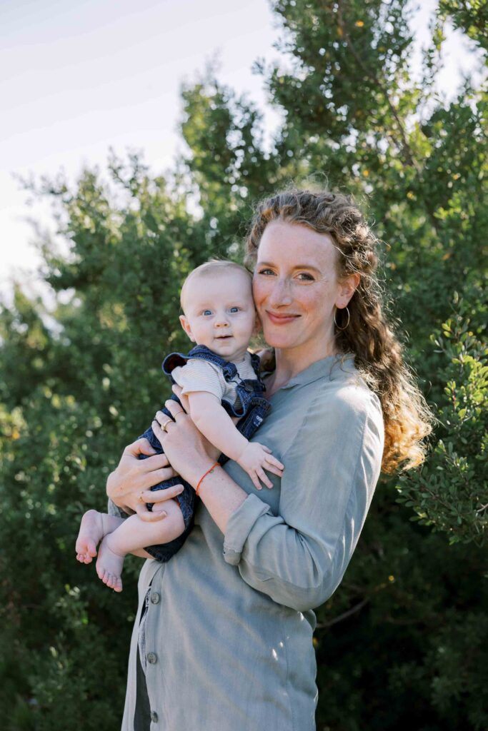 Mother holding her baby boy on a beach