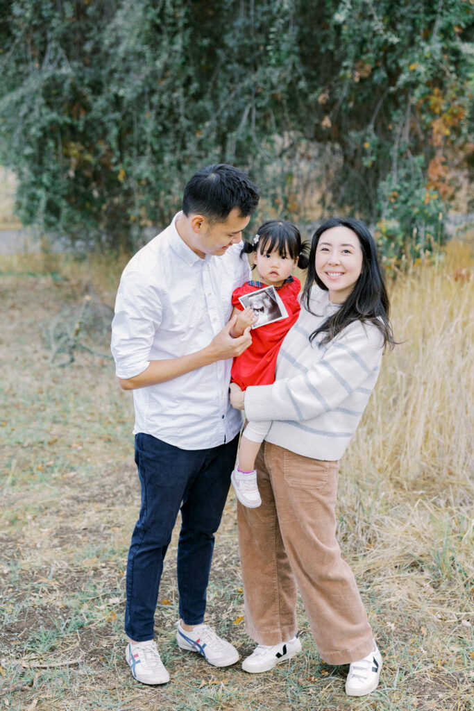 Young family with toddler smiling for a photo at Arastradero Preserve