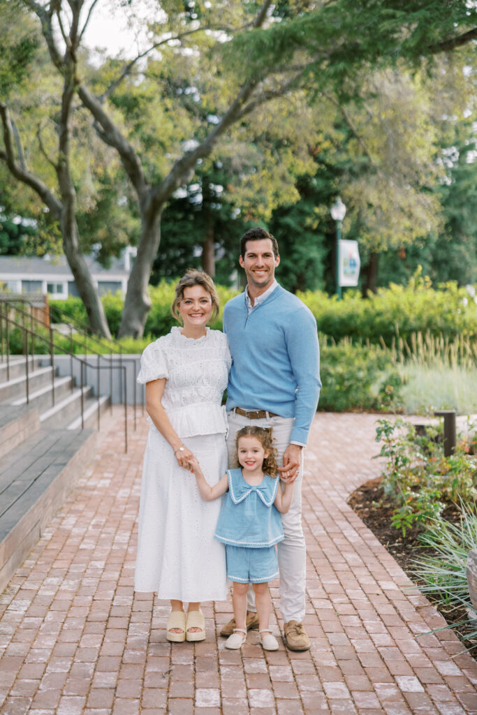 Family of 3 standing in a garden-like setting during Bay Area Mini Sessions in Atherton