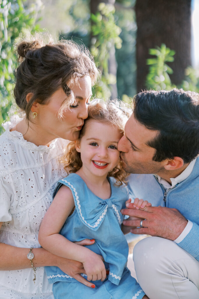 Family of 3 canoodling in a garden-like setting during Bay Area Mini Sessions in Atherton